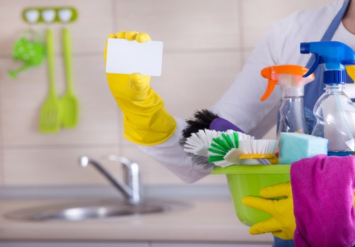 Cleaner working in a modern E14 apartment living room