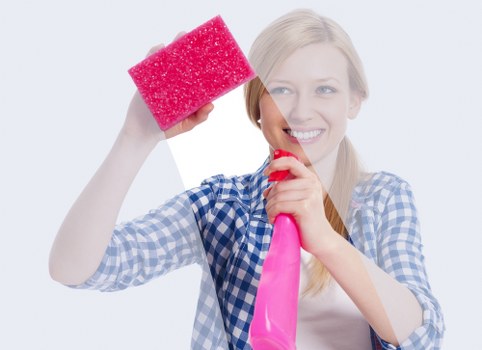 Insured carpet cleaners assessing a room before cleaning in E14